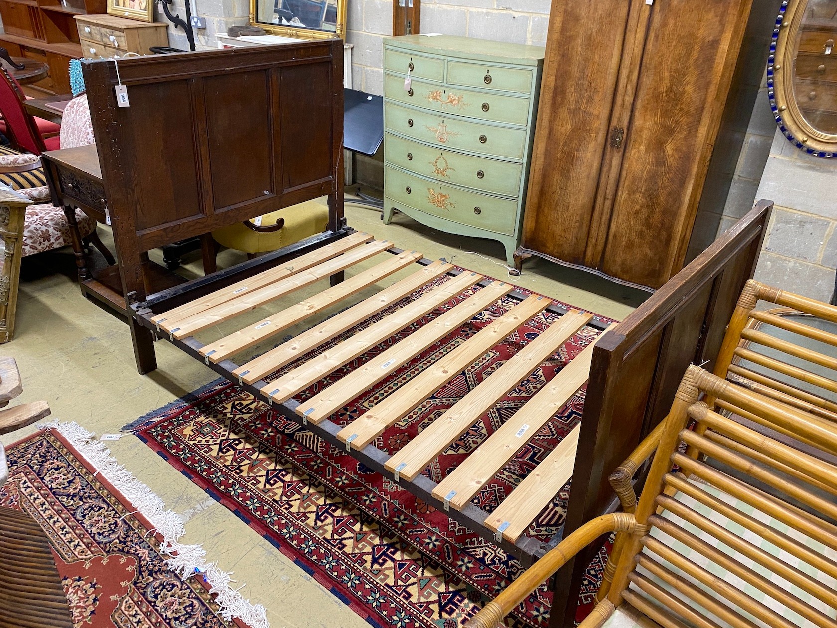 An 18th century style panelled oak bedframe, length 198cm, width 122cm, height 130cm